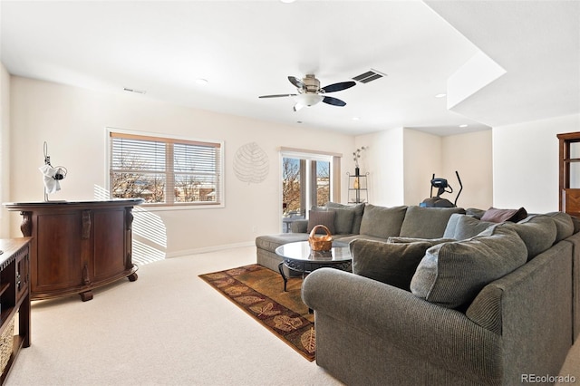 carpeted living room featuring ceiling fan