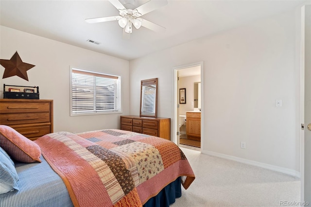 bedroom featuring ceiling fan, light carpet, and connected bathroom