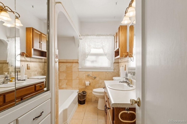 bathroom featuring vanity, tile patterned flooring, toilet, tile walls, and a tub