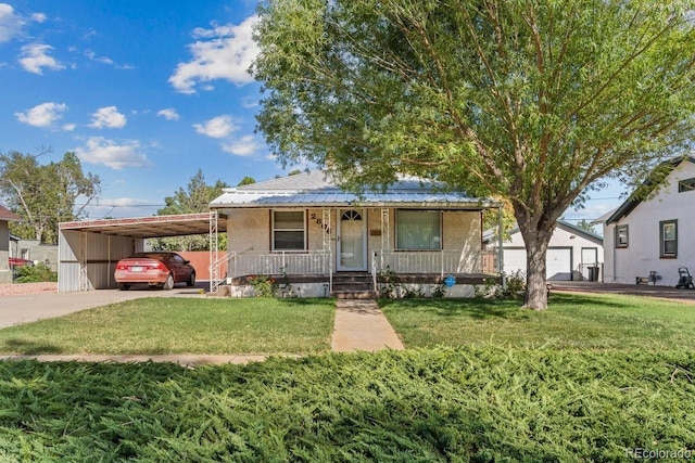 view of front facade featuring a front yard, a porch, and a carport