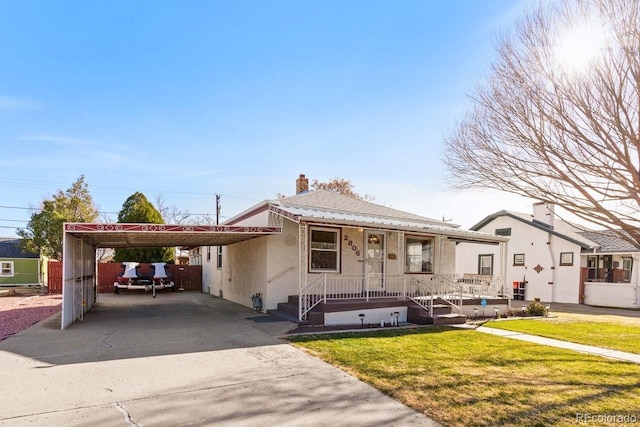 view of front facade featuring a front lawn and a carport