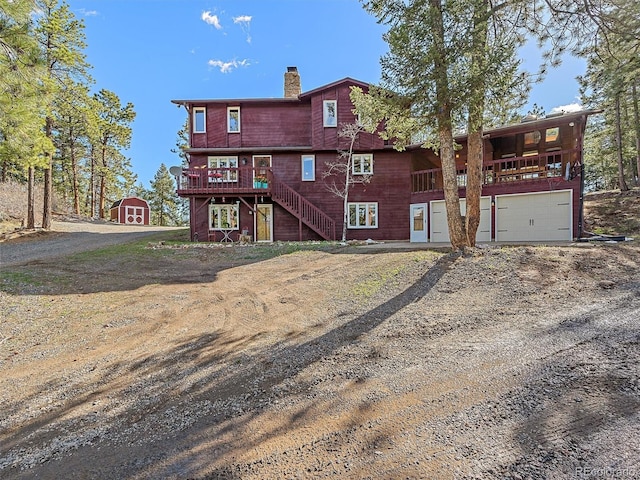 view of front of property featuring a shed and a wooden deck