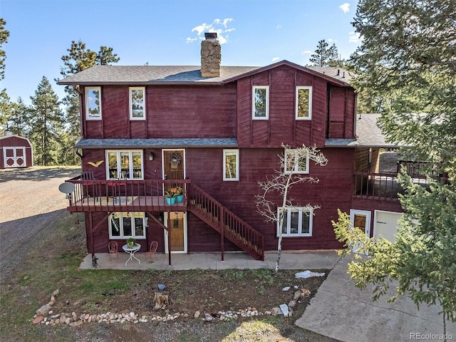 rear view of house featuring a patio and a deck