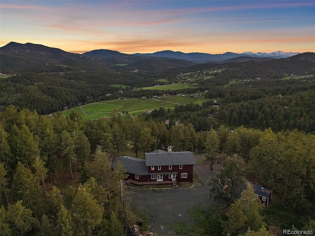 aerial view at dusk featuring a mountain view