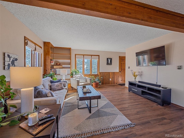 living room with a textured ceiling, wooden walls, and hardwood / wood-style flooring