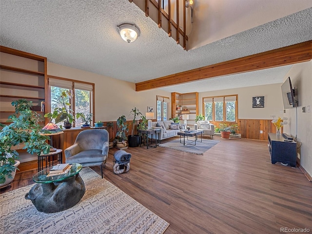 living room with a wealth of natural light, wood-type flooring, and a textured ceiling