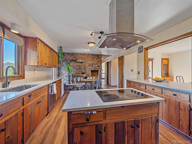 kitchen featuring sink, black electric stovetop, stainless steel dishwasher, island exhaust hood, and light wood-type flooring