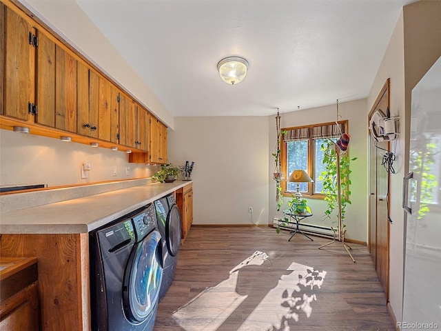 clothes washing area with separate washer and dryer, a baseboard radiator, and dark wood-type flooring