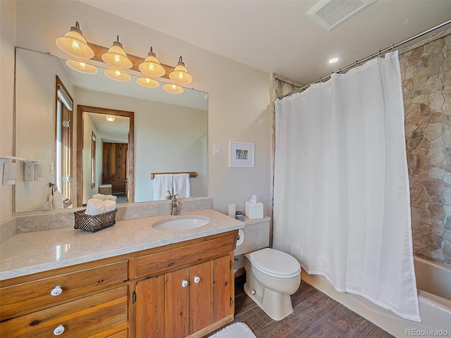 full bathroom with shower / bath combo, wood-type flooring, vanity, and toilet