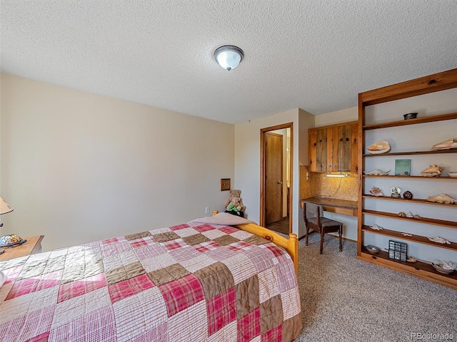 bedroom with a textured ceiling and carpet