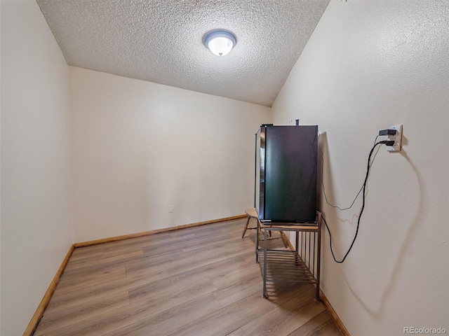 misc room featuring light hardwood / wood-style floors and a textured ceiling