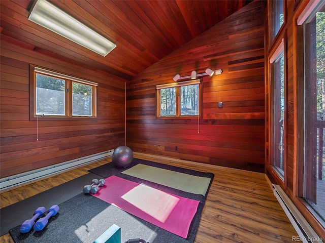 workout area featuring wood walls, wooden ceiling, baseboard heating, lofted ceiling, and dark hardwood / wood-style flooring