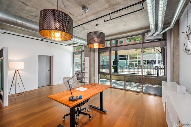 home office with light hardwood / wood-style floors