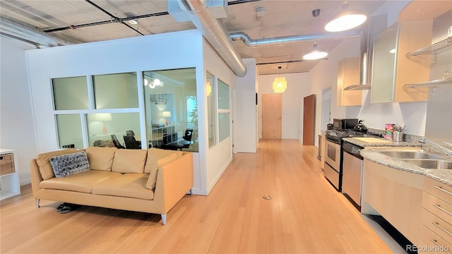 kitchen with range with gas stovetop, light wood-type flooring, pendant lighting, dishwasher, and sink