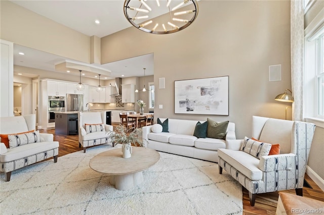 4193 W 99th Ct, Westminster, CO 80031 - living area with wood finished floors, healthy amount of natural light, a chandelier, recessed lighting, and a high ceiling