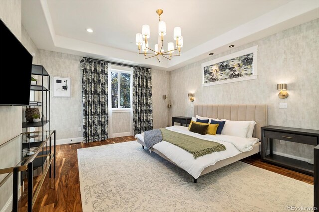 4193 W 99th Ct, Westminster, CO 80031 - bedroom with wallpapered walls, dark wood-style floors, a chandelier, baseboards, and a raised ceiling