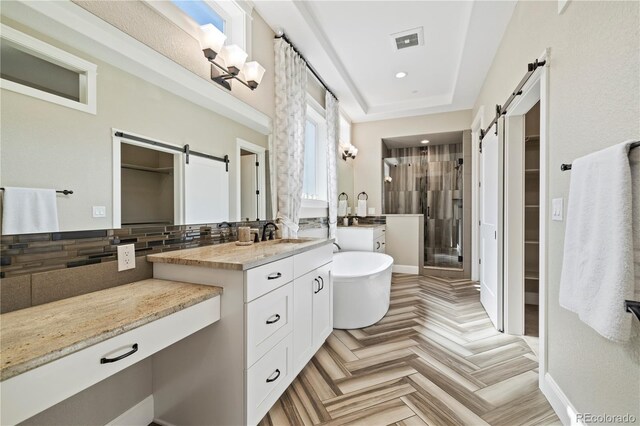 4193 W 99th Ct, Westminster, CO 80031 - bathroom with a spacious closet, a shower stall, vanity, a freestanding tub, and recessed lighting
