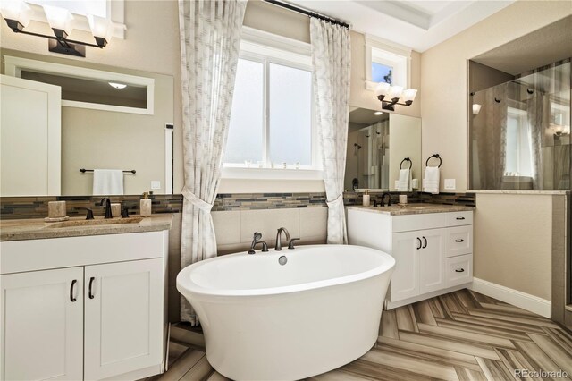 4193 W 99th Ct, Westminster, CO 80031 - full bathroom featuring two vanities, a soaking tub, and a walk in shower