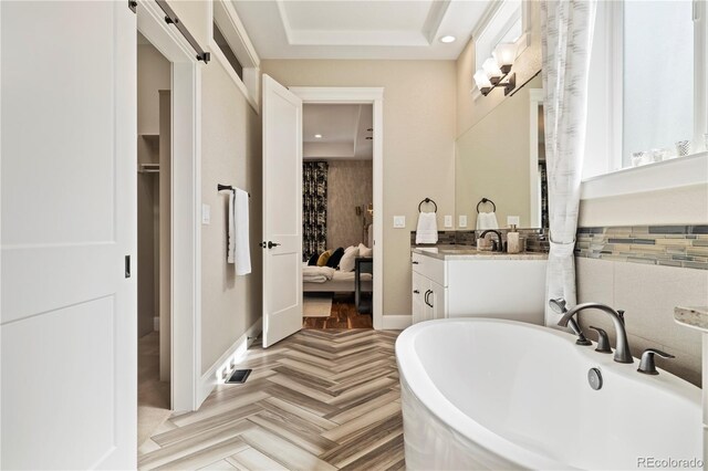4193 W 99th Ct, Westminster, CO 80031 - bathroom featuring vanity, a freestanding bath, baseboards, and recessed lighting