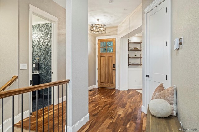 4193 W 99th Ct, Westminster, CO 80031 - corridor with dark wood-style floors, a textured wall, a chandelier, and baseboards