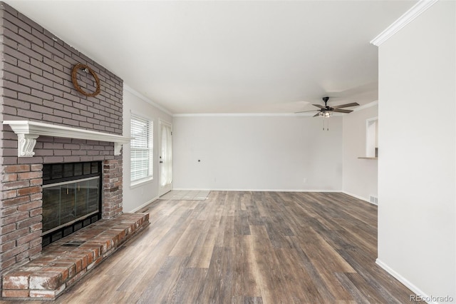 5316 S Jellison St, Littleton, CO 80123 - unfurnished living room featuring wood finished floors, ceiling fan, crown molding, a brick fireplace, and baseboards