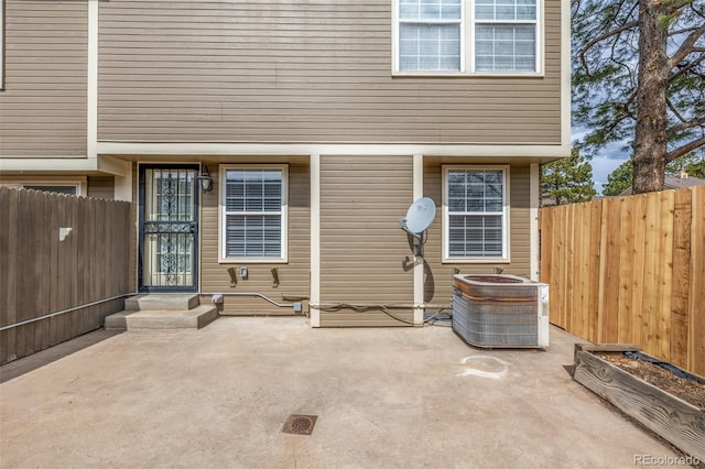 5316 S Jellison St, Littleton, CO 80123 - doorway to property featuring central AC, fence, and a patio