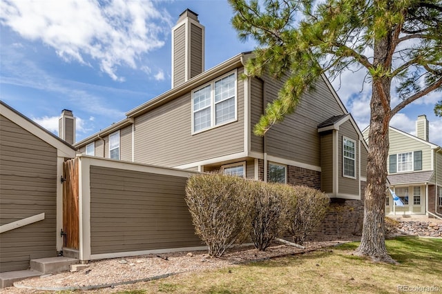 5316 S Jellison St, Littleton, CO 80123 - view of property exterior featuring a chimney and brick siding