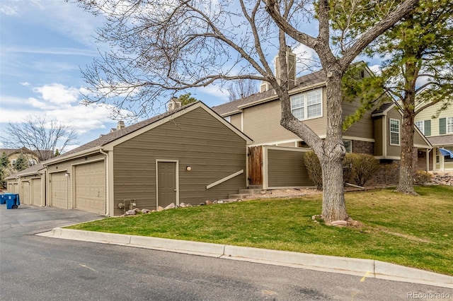5316 S Jellison St, Littleton, CO 80123 - view of front of property featuring a front yard, a chimney, and a garage