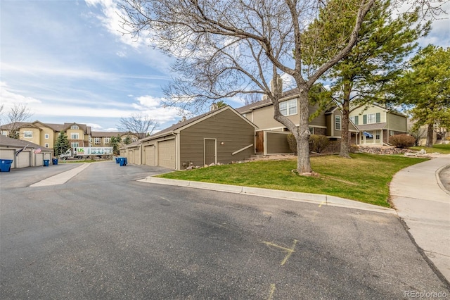 5316 S Jellison St, Littleton, CO 80123 - view of front of property with a residential view, a front lawn, and community garages