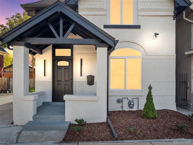 view of exterior entry at dusk