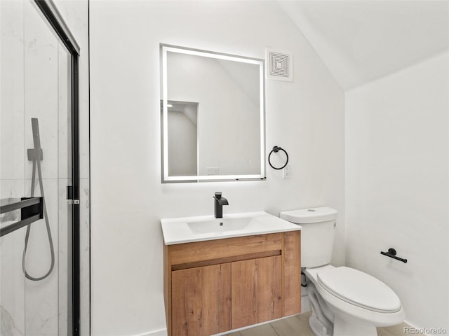 bathroom featuring vanity, lofted ceiling, tile patterned floors, and toilet