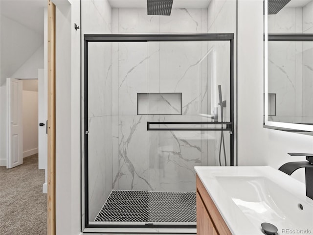 bathroom featuring vanity and a shower with shower door