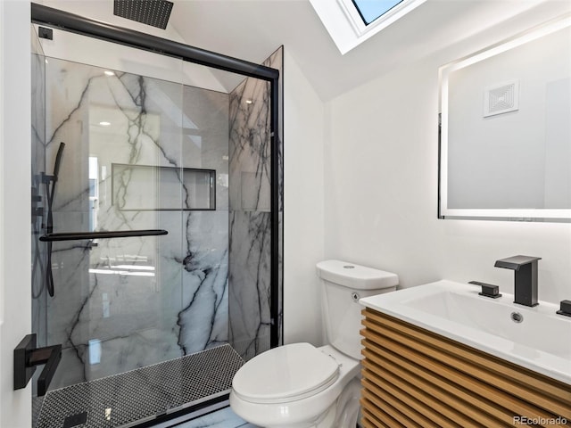 bathroom featuring vanity, a shower with shower door, toilet, and vaulted ceiling with skylight