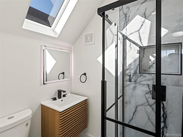 bathroom with toilet, vanity, vaulted ceiling with skylight, and an enclosed shower