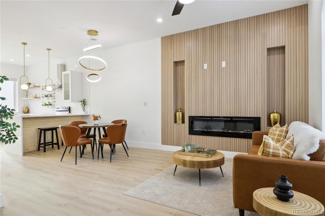 living room featuring ceiling fan and light wood-type flooring