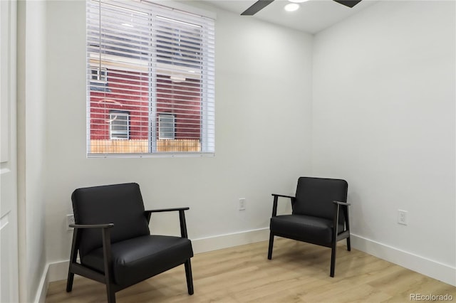 living area with ceiling fan and light wood-type flooring