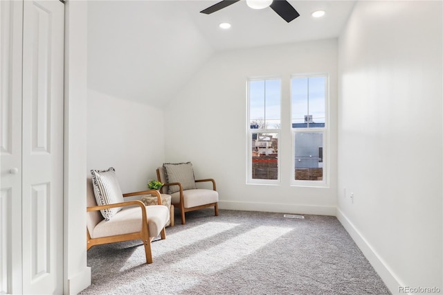 sitting room with ceiling fan, carpet flooring, and vaulted ceiling