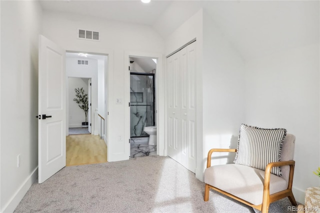 living area with vaulted ceiling and light carpet