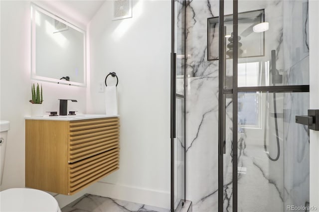 bathroom with vanity, toilet, and a shower with door