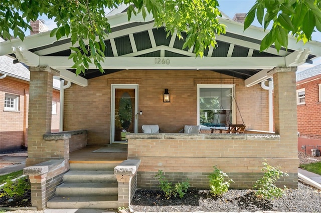 view of exterior entry featuring a porch