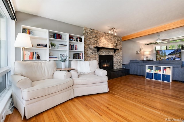 4545 S Lipan Ct, Englewood, CO 80110 - living room with light wood-type flooring, a fireplace, and a ceiling fan