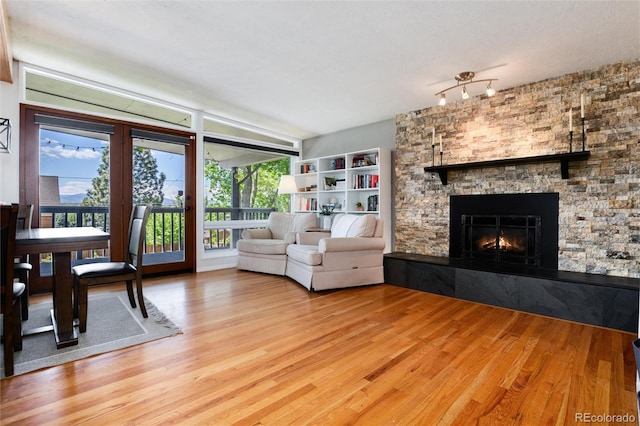 4545 S Lipan Ct, Englewood, CO 80110 - living area with a stone fireplace and light wood-style floors