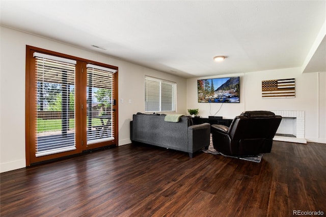 4545 S Lipan Ct, Englewood, CO 80110 - living area featuring wood finished floors, baseboards, and a brick fireplace