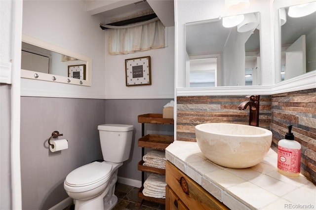 4545 S Lipan Ct, Englewood, CO 80110 - half bathroom with toilet, vanity, wainscoting, and baseboards