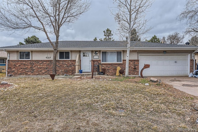 ranch-style home with a garage, concrete driveway, brick siding, and stucco siding