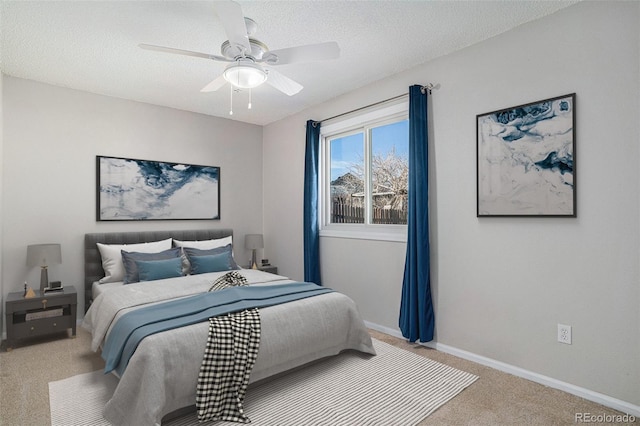 bedroom featuring carpet flooring, ceiling fan, and a textured ceiling