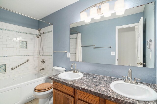 full bathroom featuring vanity, shower / tub combo, and toilet