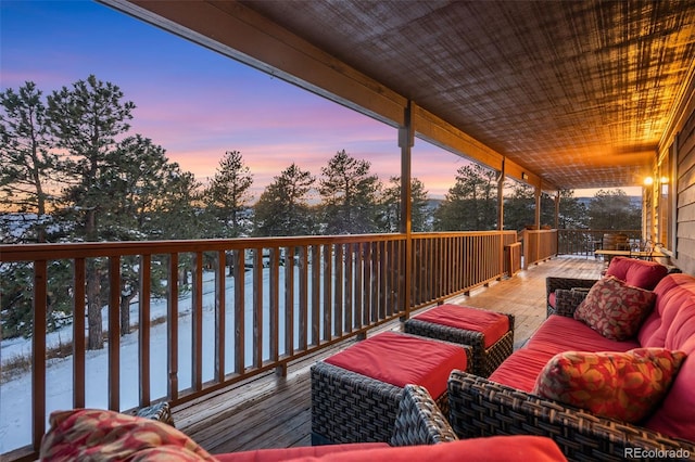 deck at dusk with an outdoor living space