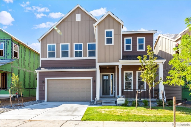 5626 W 142nd Ave, Broomfield, CO 80020 - view of front of home with board and batten siding, an attached garage, covered porch, concrete driveway, and a front yard
