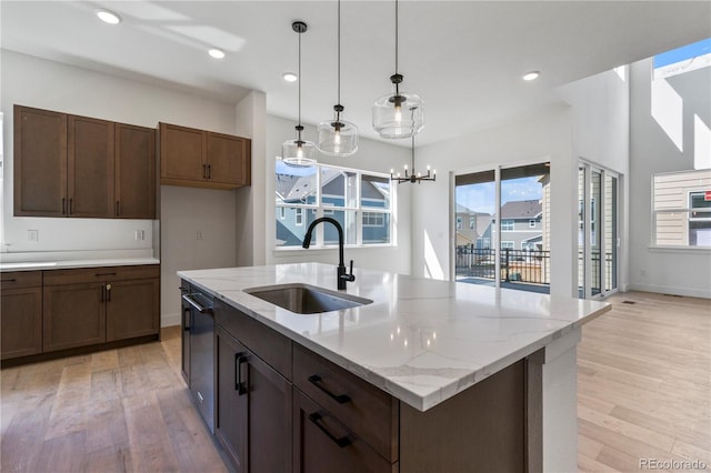 5626 W 142nd Ave, Broomfield, CO 80020 - kitchen featuring light wood finished floors, healthy amount of natural light, hanging light fixtures, and recessed lighting